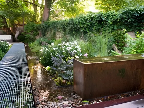 Dense welded steel grating walkway installed in a garden terrace.